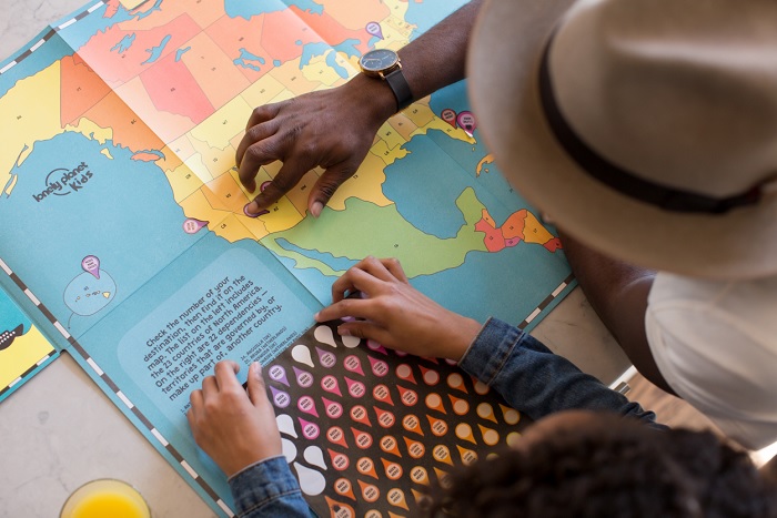 map, learning, America, states, USA, North America, blue, yellow, red, green, hat, jean jacket, white, 